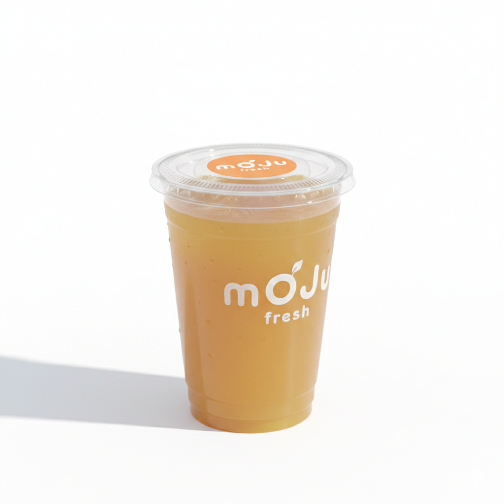 Sealed Mojufresh cup of fresh orange juice from inside a juice vending machine