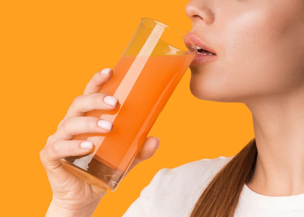 Person enjoying fresh orange juice